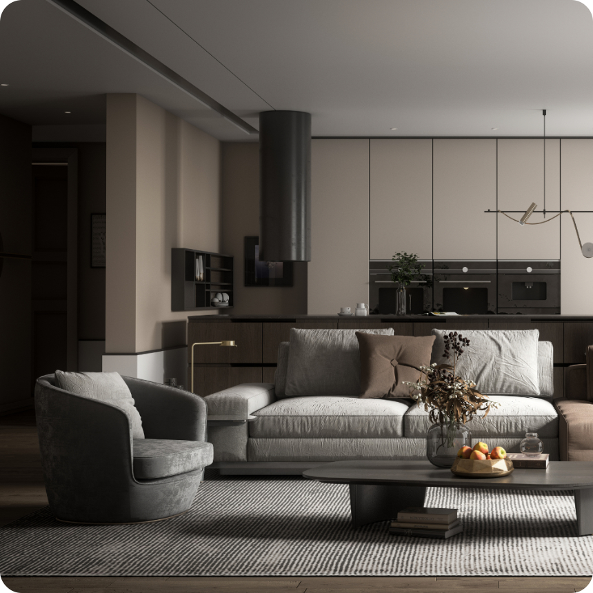 Modern living room with a grey sofa, round armchair, coffee table with dried flowers and fruit, and an open kitchen in the background with neutral tones and minimalist decor.